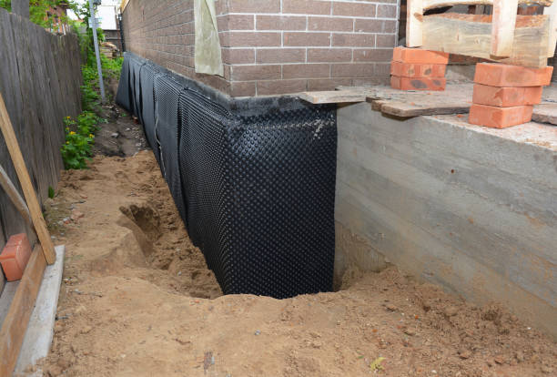 SJ Waterproofing Pros technician performing targeted Basement Waterproofing assessment in Sullivan, IL